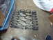 2003 Acura TL - Multiple sets of coil springs are arranged on the floor next to a blue storage bin.