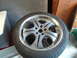 2003 Acura TL - A single car wheel is shown in this close-up photo, resting on a surface indoors.