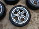 2003 Acura TL - Four alloy wheels and tires are displayed on a concrete surface. The registry claims they are from a 2003 Acura TL, but this cannot be conf…