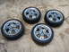 2003 Acura TL - Set of four alloy wheels and tires are displayed on a concrete ground.