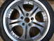 2003 Acura TL - A close-up view of a single alloy wheel and tire, showing its intricate spoke design and polished rim.