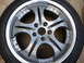 2003 Acura TL - A close-up view of a silver alloy wheel and tire, a multi-spoke design and visible lug nut holes.