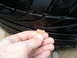 2003 Acura TL - A hand holds a penny to check the tread depth of a tire.