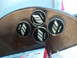 2003 Acura TL - Close-up of four WORK emblems, possibly from a vehicle wheel or accessory.