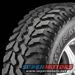 Close-up of a large, aggressive off-road tire with 'DESTINAT' visible on the sidewall. Supermotors.net logo at bottom