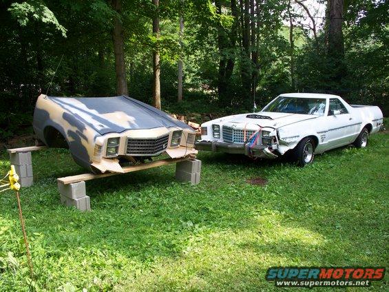 Front clip of a 1977 Ford Ranchero on blocks, next to a damaged white 1977 Ford Ranchero