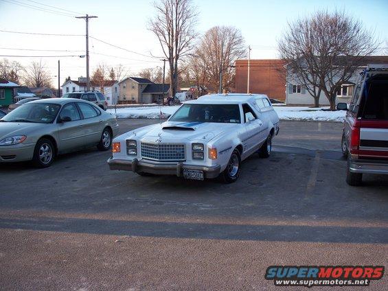 White 1979 Ford Ranchero with hood scoop and blue stripes