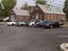 1993 Ford Mustang - A black 1993 Ford Mustang coupe with a yellow roof is parked in a lot alongside other vehicles.
