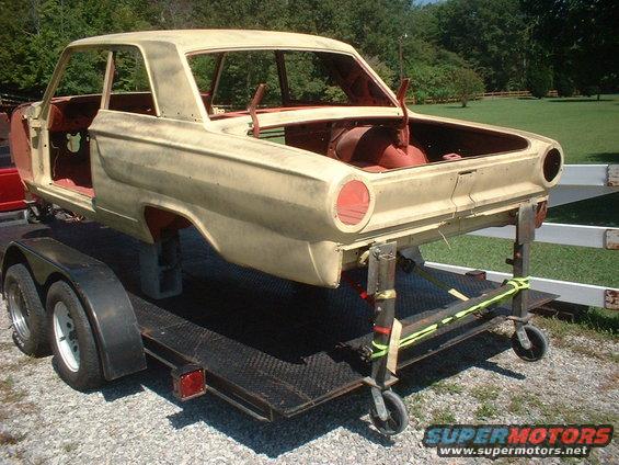 1964 Ford Fairlane body on trailer, rear quarter view, primer yellow