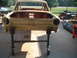 1964 Ford Fairlane - The front end of a car body is shown, mounted on rolling stands for restoration.