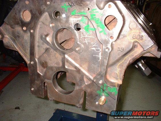 Engine block with green markings and a brass plug