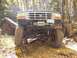 1994 Ford Bronco - 1994 Ford Bronco on a rocky trail with trees and fallen leaves.