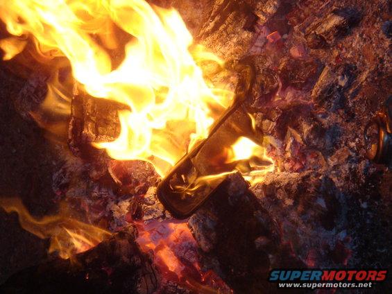 Fire burning logs with SUPERMOTORS text at bottom right