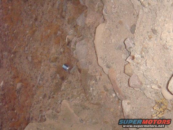 Rocky ground with a silver can lying on its side