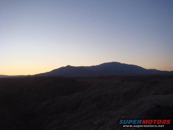 Desert mountains and terrain at sunset with a clear sky