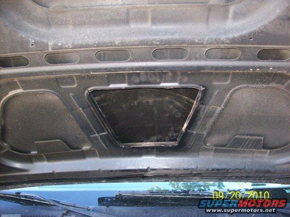 underside of car hood with a cut-out opening