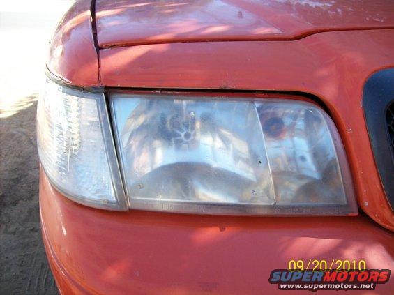 Red 2002 Ford Crown Victoria front headlight