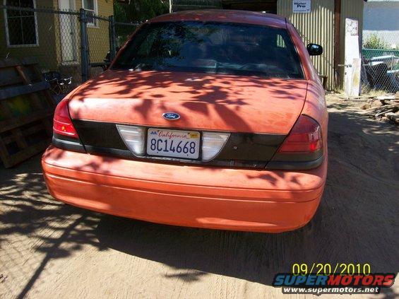 Orange 2002 Ford Crown Victoria rear view with California license plate 8C14668
