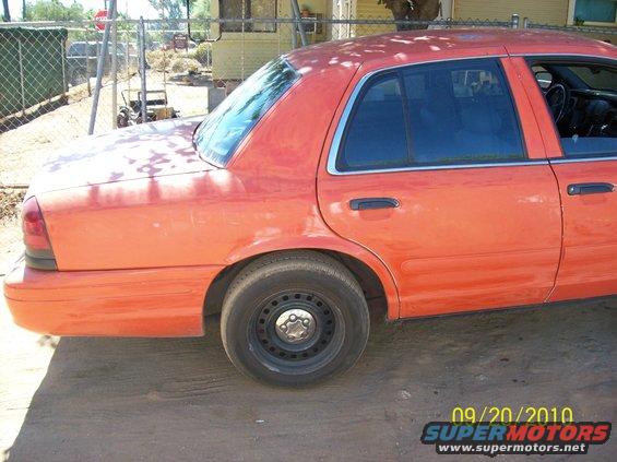 2002 Ford Crown Victoria side view, orange paint