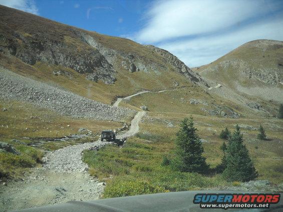Jeep Wrangler driving up a rocky mountain road