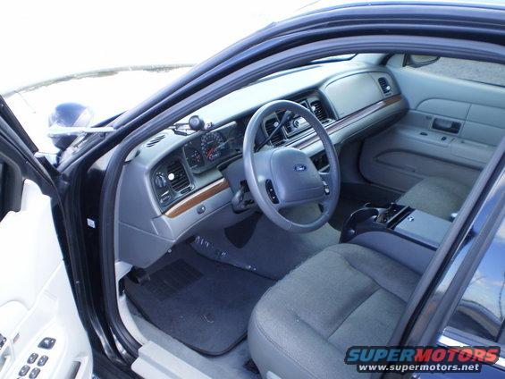 Interior shot of a Ford Crown Victoria showing the dashboard, steering wheel, and front seats