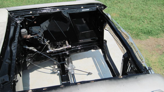 Cleaned and painted engine bay of a classic car, showing brake master cylinder and steering components