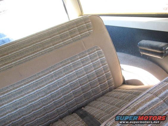 Striped fabric seats and door panel with armrest inside a vehicle