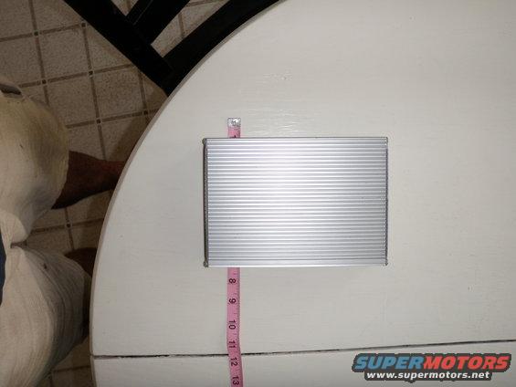 Silver ribbed electronic part with pink measuring tape