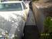 1978 Ford Ranchero - A 1978 Ford Ranchero is parked in a narrow concrete driveway next to a retaining wall.