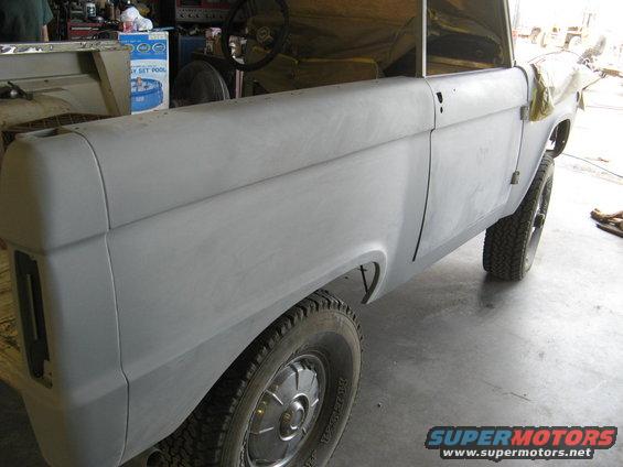 1966 Ford Bronco body in primer, side view, showing fender and door