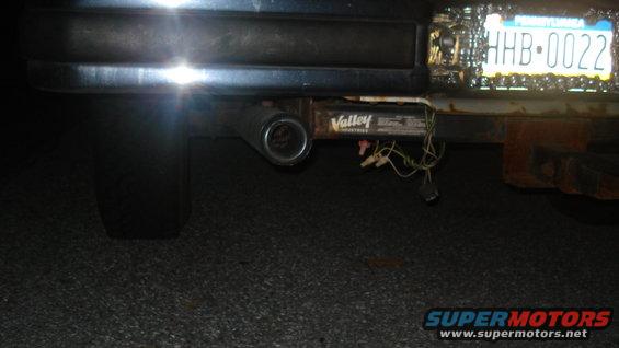 Vehicle's rear bumper, trailer hitch with a 'Valley Industries' label, and a license plate reading 'HHB-0022'