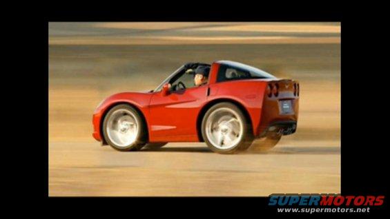 Red sports car with comically large wheels driving on a dirt road