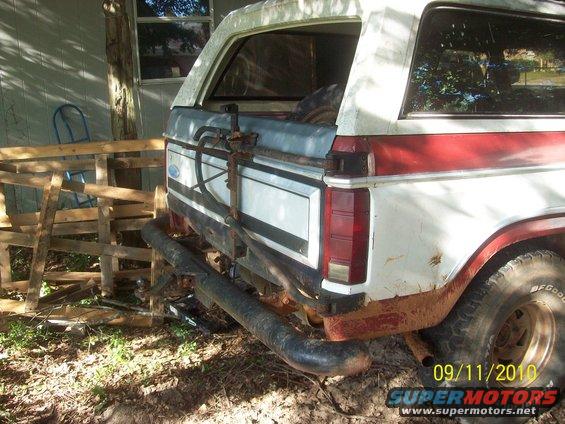 White and red Ford Bronco rear with spare tire carrier and aftermarket bumper