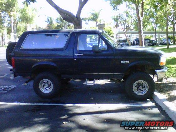 Black 1995 Ford Bronco side view with spare tire on rear