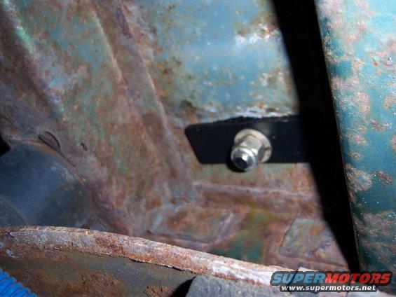 Child seat tether anchor bolt on rusty metal