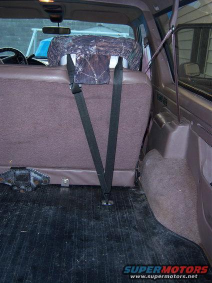 Rear seat and cargo area of a 1996 Ford Bronco. Shows seatbelts and seat covers