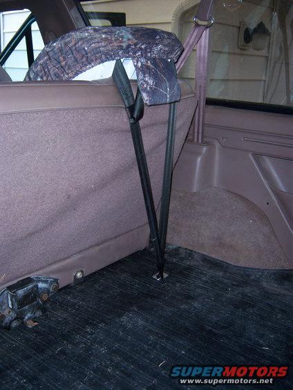 Interior rear seat with camouflage seat cover and child seat tethers