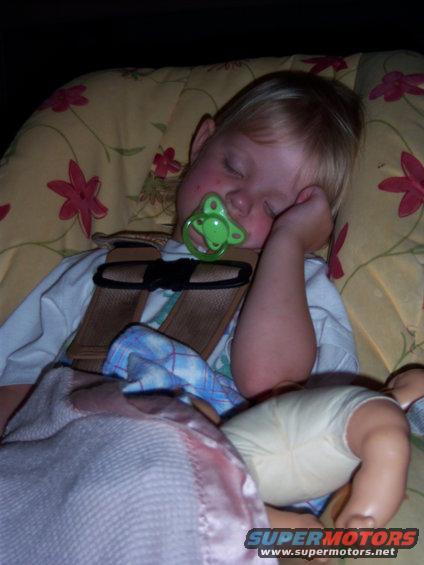 Child sleeping in car seat with pacifier