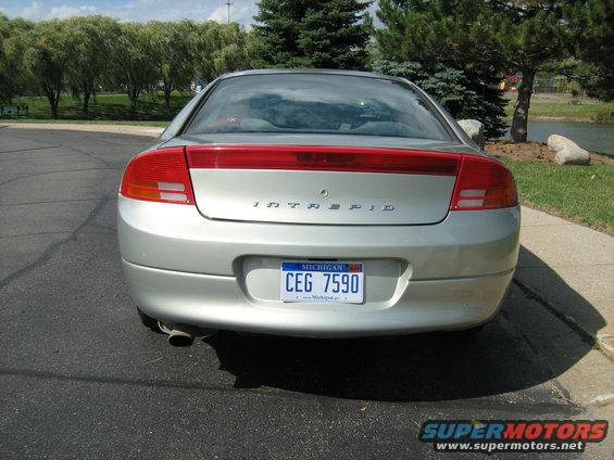 Rear view of a silver sedan with 'INTREPID' badge and Michigan license plate CEG 7590