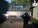 1980 Jeep Cherokee - The rear of a Jeep Cherokee is shown parked in a driveway, with a shadow of the photographer visible on the tailgate.
