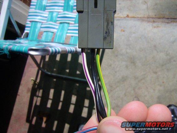 Gray electrical connector with purple, white, black, and green wires
