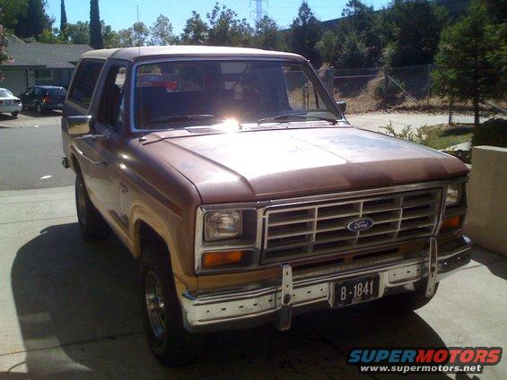 1986 Ford Bronco parked in a driveway, front 3/4 view