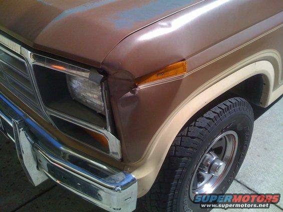 Brown 1986 Ford Bronco front fender with dent and amber turn signal