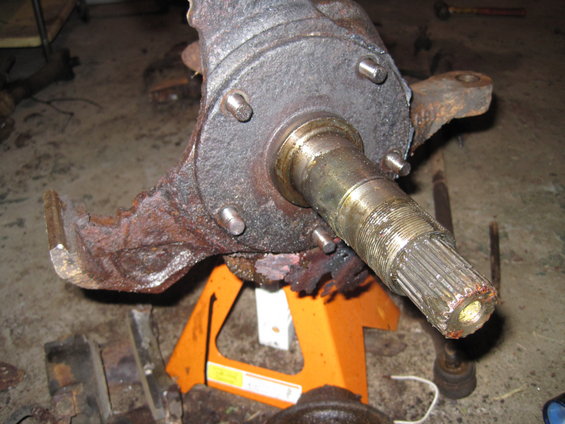 rusted vehicle spindle assembly on orange jack stands