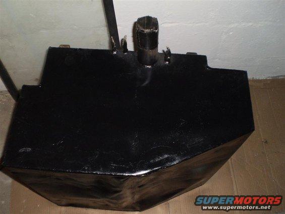 Black metal fuel tank with a pipe fitting on top, viewed from a 3/4 front angle