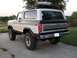 1978 Ford Bronco - Rear view of a two-tone 1978 Ford Bronco with a roof rack and cargo box.