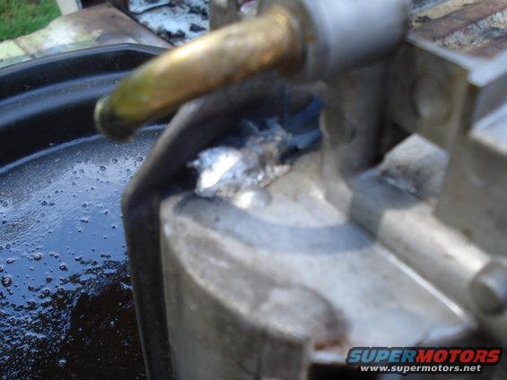 Engine part with metal debris and oil
