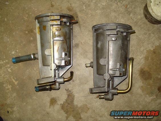 two old fuel filters, one with a blue-tipped hose attached