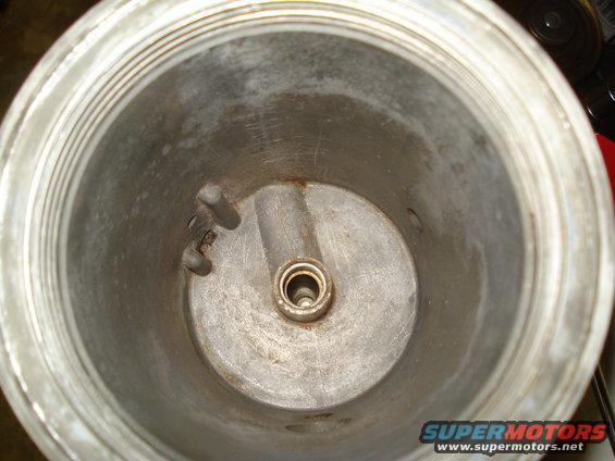Interior of metal canister with central spindle and threaded rim