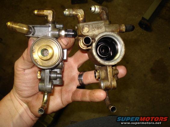 Two oil filter housings, one with a brass filter element, held in a hand